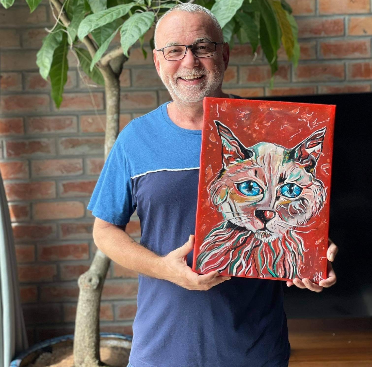 Happy customer holding his painting of his Siamese cat